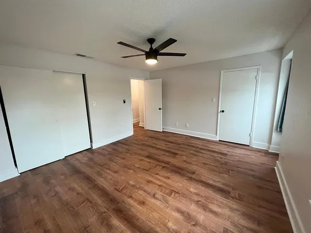 a view of a livingroom with a ceiling fan & a ceiling fan