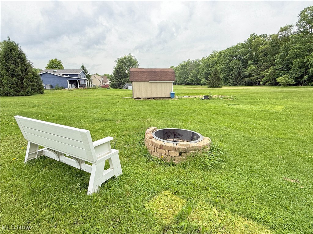 11737 Gladstone Road Warren, OH 44481 - Photo 33 of 41 View of green lawn featuring an outdoor fire pit
