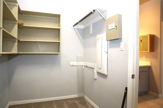 a bathroom with a tub shower and checkered floor