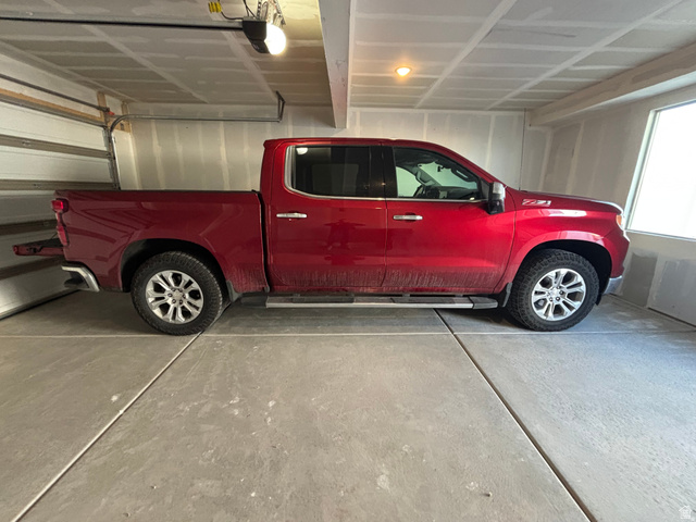 636 West Caroles Way, Unit 7 Tooele, UT 84074 - Photo 30 of 31 Spacious garage featuring a concrete floor, overhead lighting, and an automatic garage door opener
