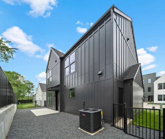 a view of a house with a wooden fence