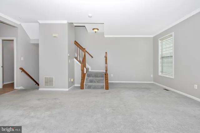 a view of an empty room with stairs