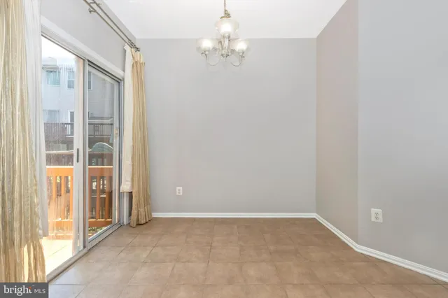 en empty room with windows and entrance