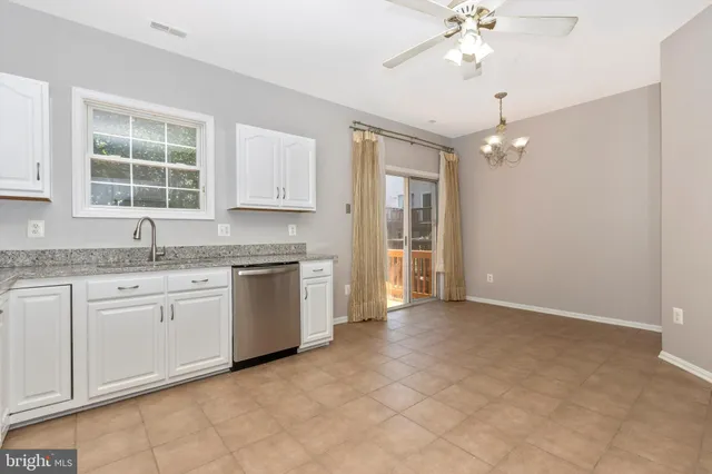 a kitchen with a stove cabinets and chandelier