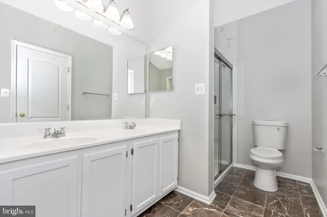 a bathroom with a sink toilet a mirror and vanity