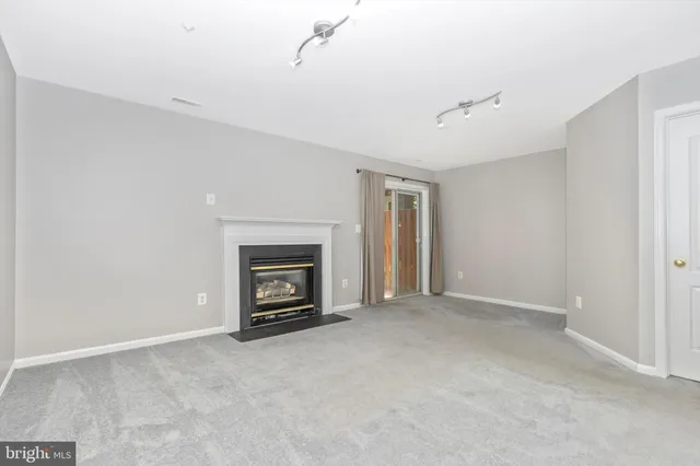 a view of an empty room with a fireplace