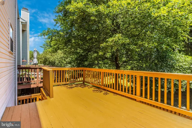 a view of balcony with wooden floor and fence