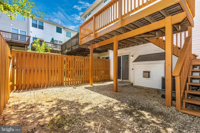 a view of backyard with a small cabin and wooden fence
