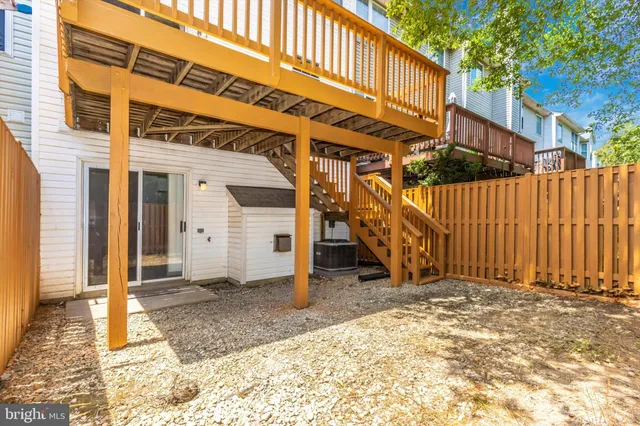 a view of a house with a wooden bench