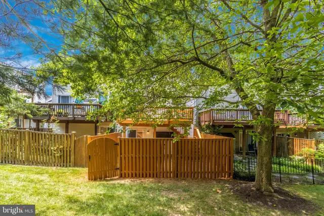 a view of a house with a wooden fence