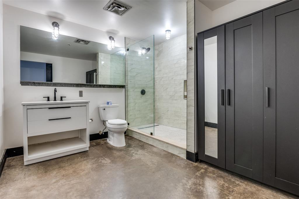 1122 Jackson Street, Unit 917 Dallas, TX 75202 - Photo 12 of 19 a bathroom with a double vanity sink toilet and shower