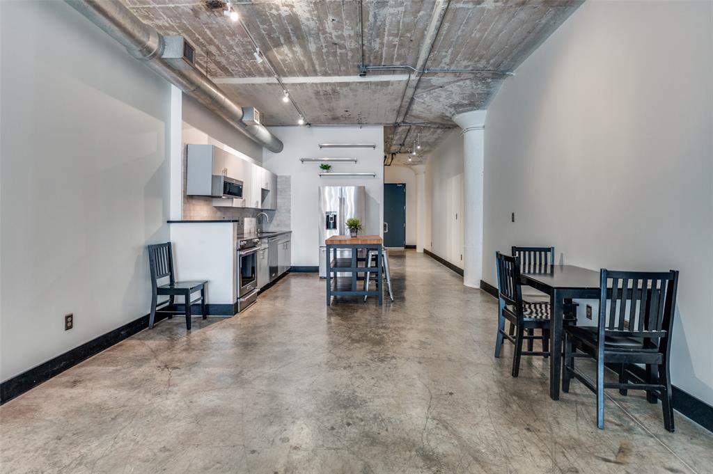 1122 Jackson Street, Unit 917 Dallas, TX 75202 - Photo 15 of 19 a dining room with furniture and a chandelier