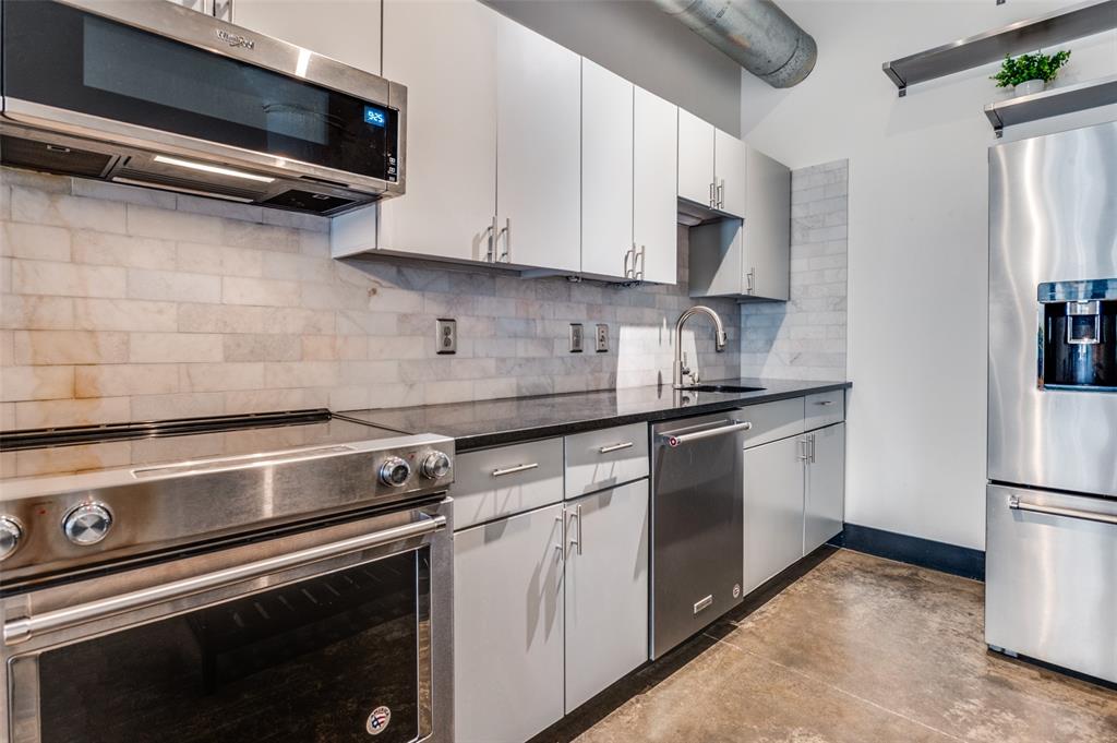 1122 Jackson Street, Unit 917 Dallas, TX 75202 - Photo 7 of 19 a kitchen with appliances a sink and cabinets