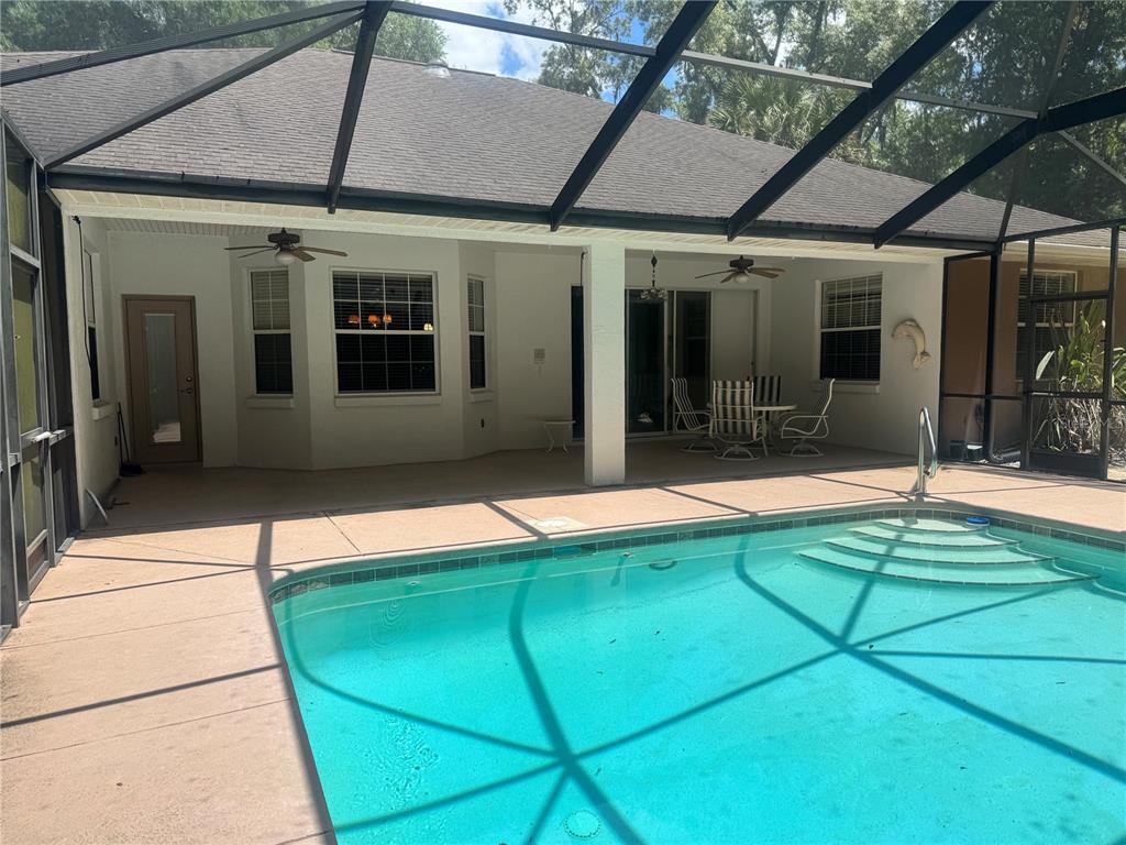 11145 Northwest 17th Court Road Ocala, FL 34475 - Photo 49 of 59 a house with swimming pool in front of it