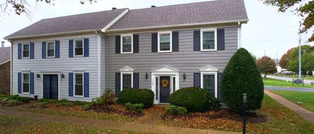 a front view of a house with garden and plants
