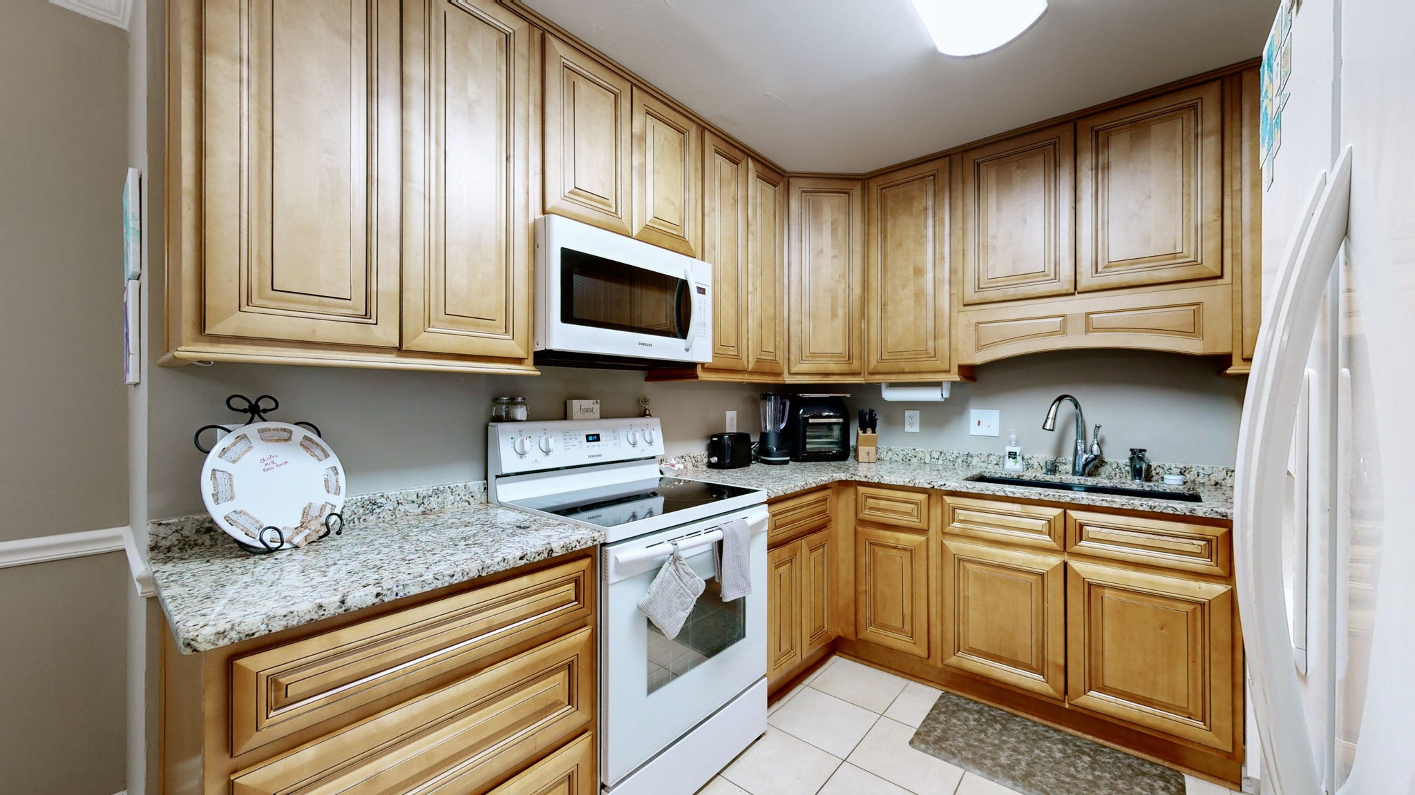 1128 General George Patton Road Nashville, TN 37221 - Photo 13 of 27 a kitchen with granite countertop cabinets stainless steel appliances and a sink