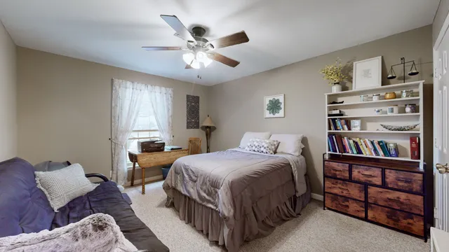 a bedroom with a bed furniture and a book shelf