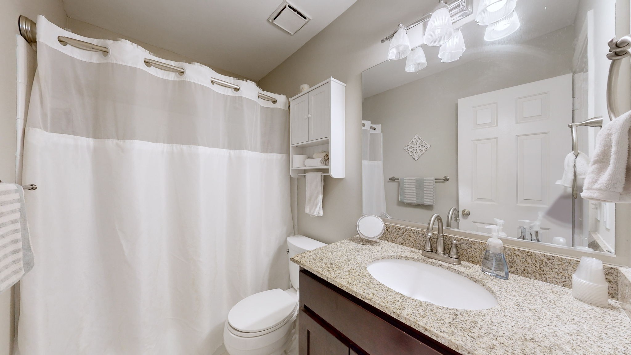 1128 General George Patton Road Nashville, TN 37221 - Photo 23 of 27 a bathroom with a granite countertop sink toilet a mirror a vanity and shower