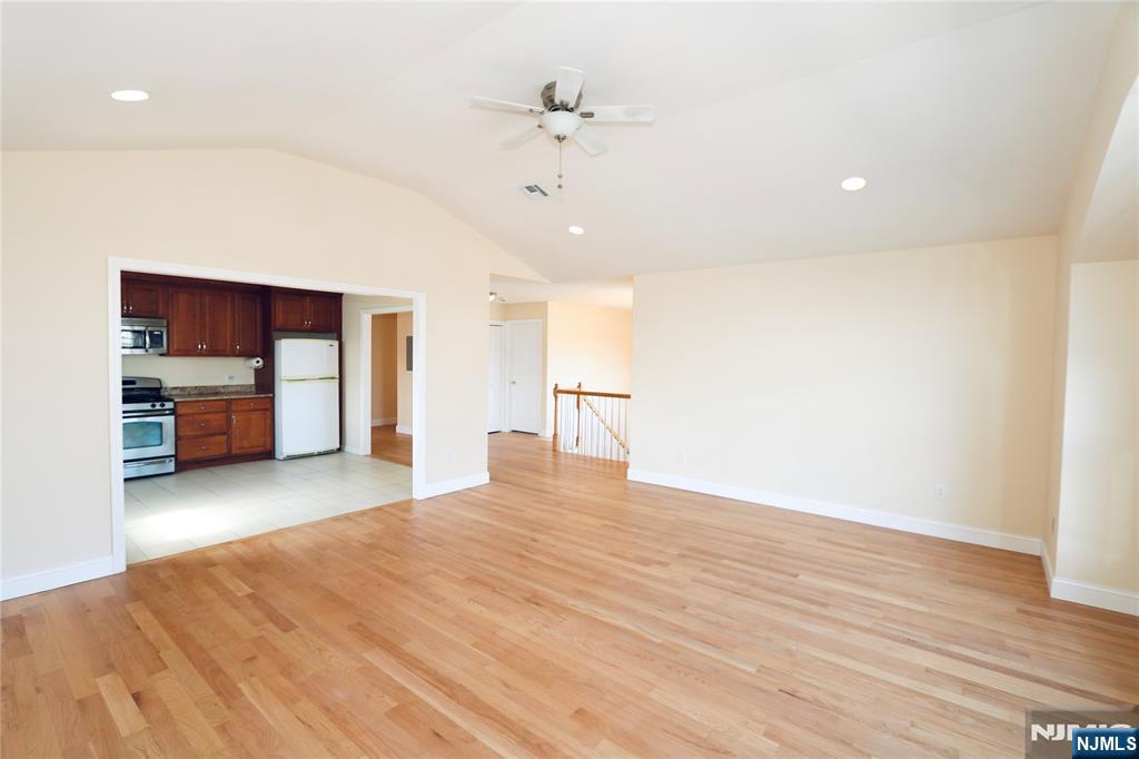 23 Main Avenue Wallington, NJ 07057 - Photo 9 of 29 a view of empty room with kitchen natural and wooden floor
