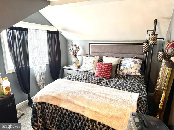 a bed room with a bed and a window