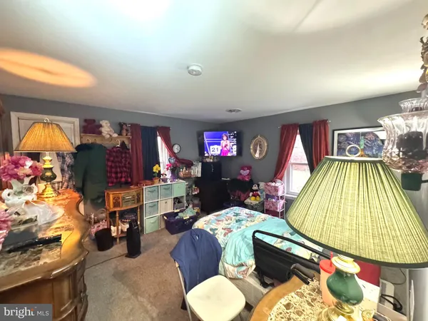 a bedroom with a bed a couch and a window