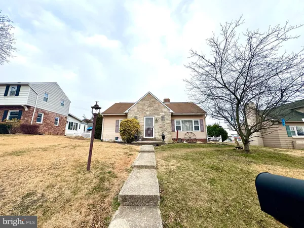 a front view of a house with a yard covered in snow