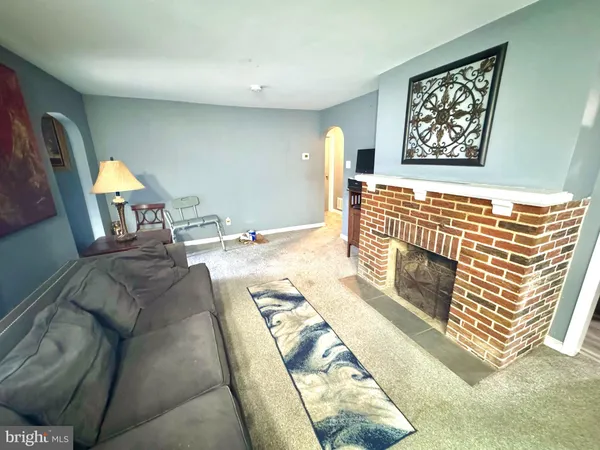 a living room with furniture a lamp and a chandelier