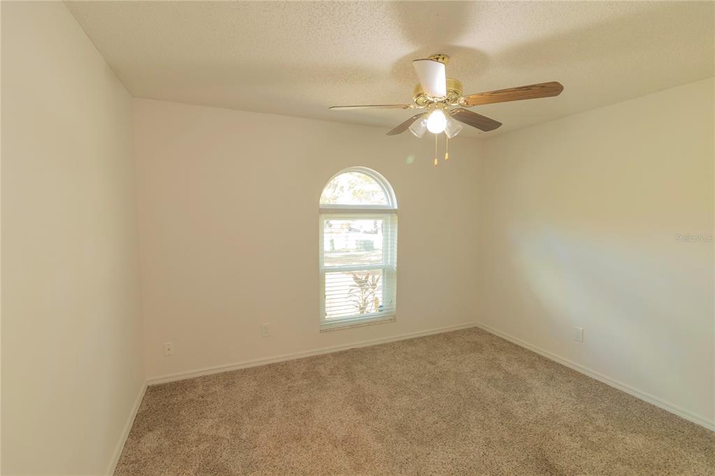 3908 Rosedale Drive Brandon, FL 33511 - Photo 12 of 44 an empty room with a window and a ceiling fan