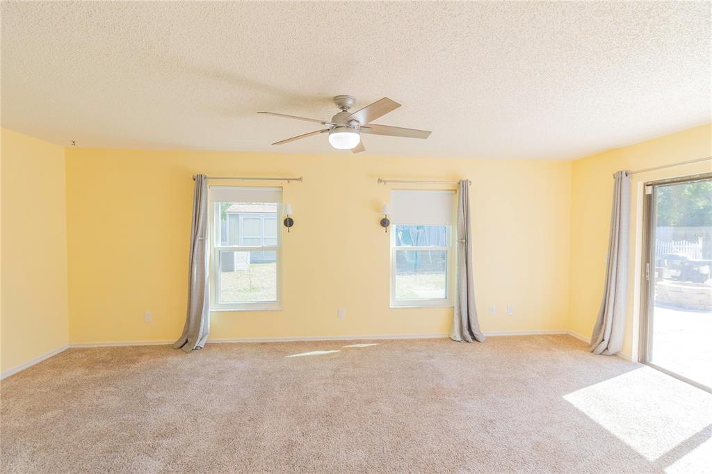 3908 Rosedale Drive Brandon, FL 33511 - Photo 19 of 44 a view of a big room with closet and a chandelier fan