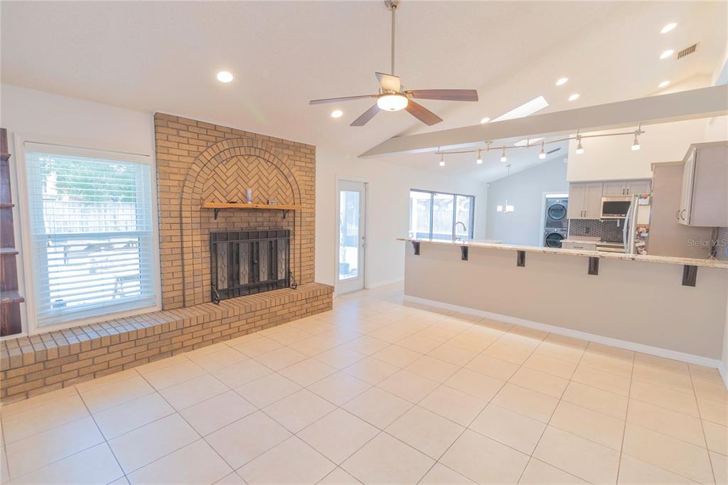 3908 Rosedale Drive Brandon, FL 33511 - Photo 26 of 44 a view of an empty room with a fireplace and a window