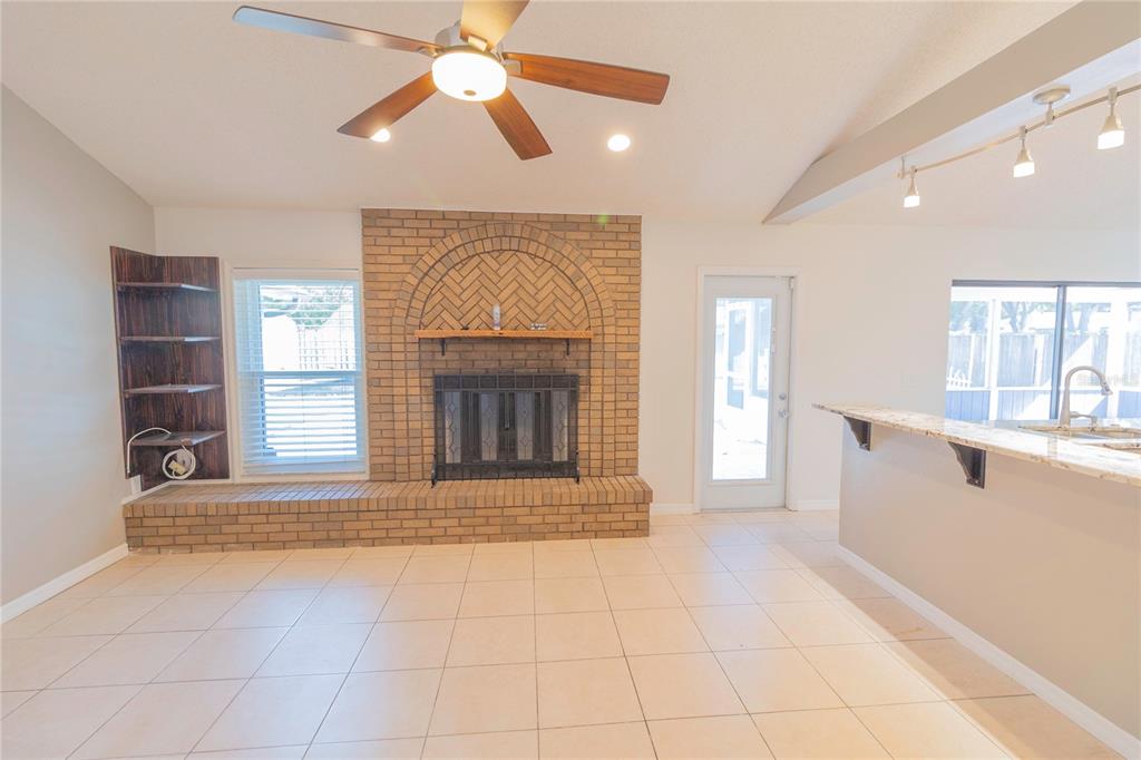 3908 Rosedale Drive Brandon, FL 33511 - Photo 28 of 44 a view of an empty room with a fireplace and a window