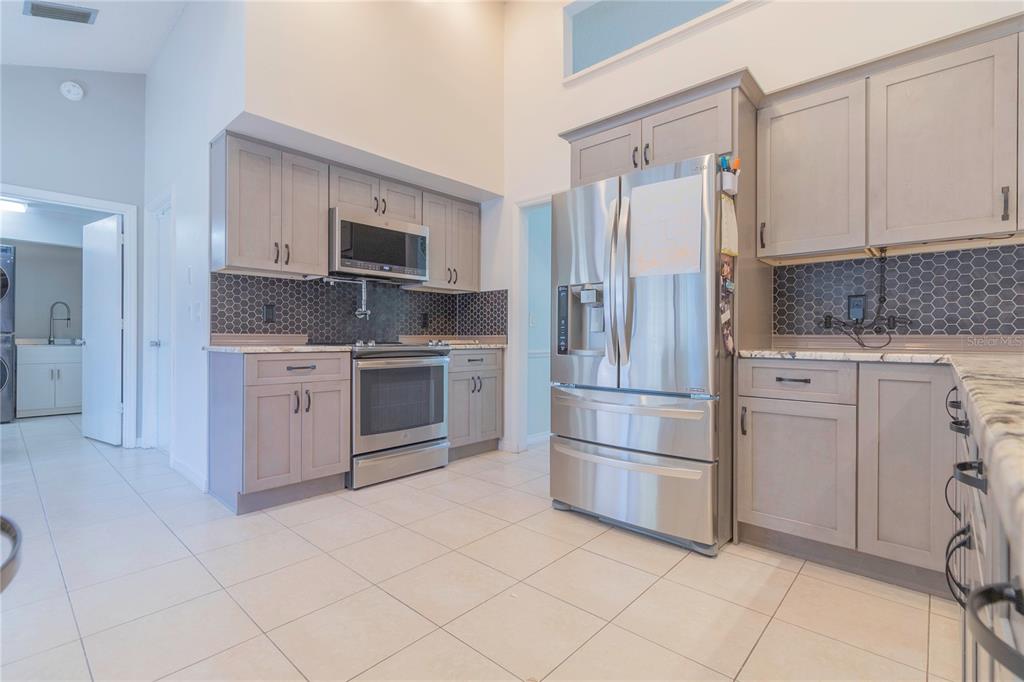 3908 Rosedale Drive Brandon, FL 33511 - Photo 31 of 44 a kitchen with stainless steel appliances a refrigerator sink and microwave