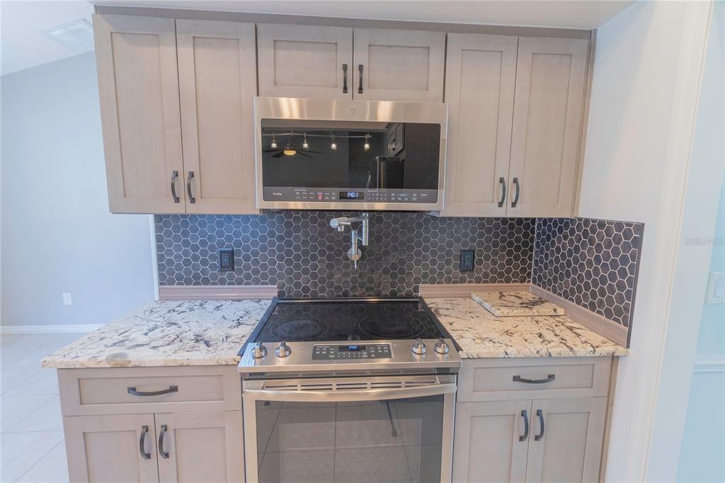 3908 Rosedale Drive Brandon, FL 33511 - Photo 33 of 44 a kitchen with a stove and cabinets