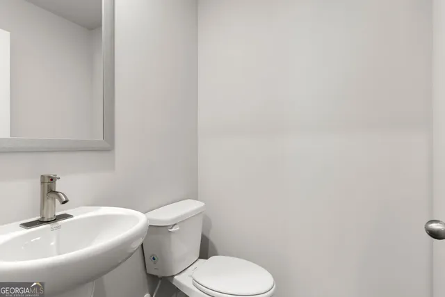 a view of a kitchen with a sink and a refrigerator