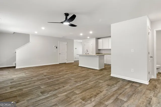 a white toilet sitting next to a white sink