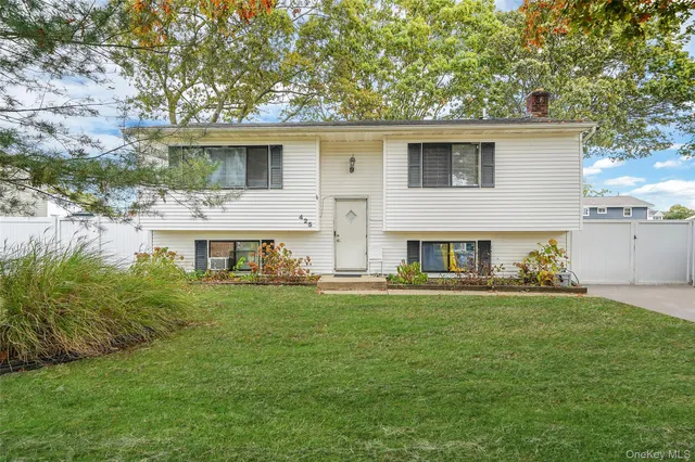 a front view of house with yard and trees