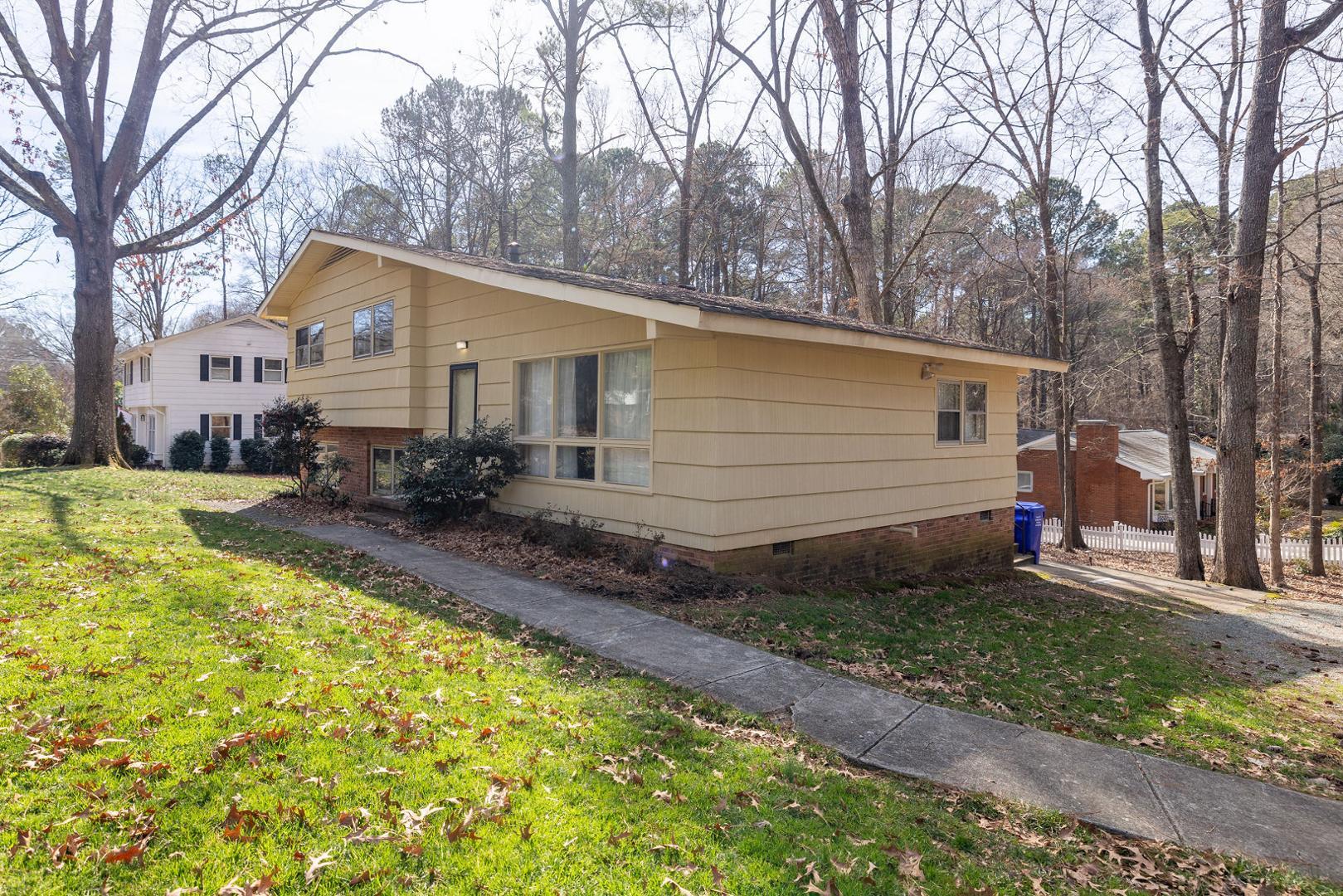 a backyard of a house with yard and outdoor seating
