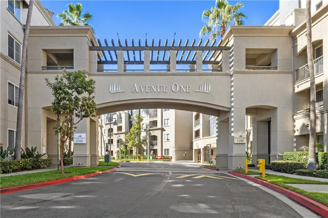 a front view of a building with a garden and plants