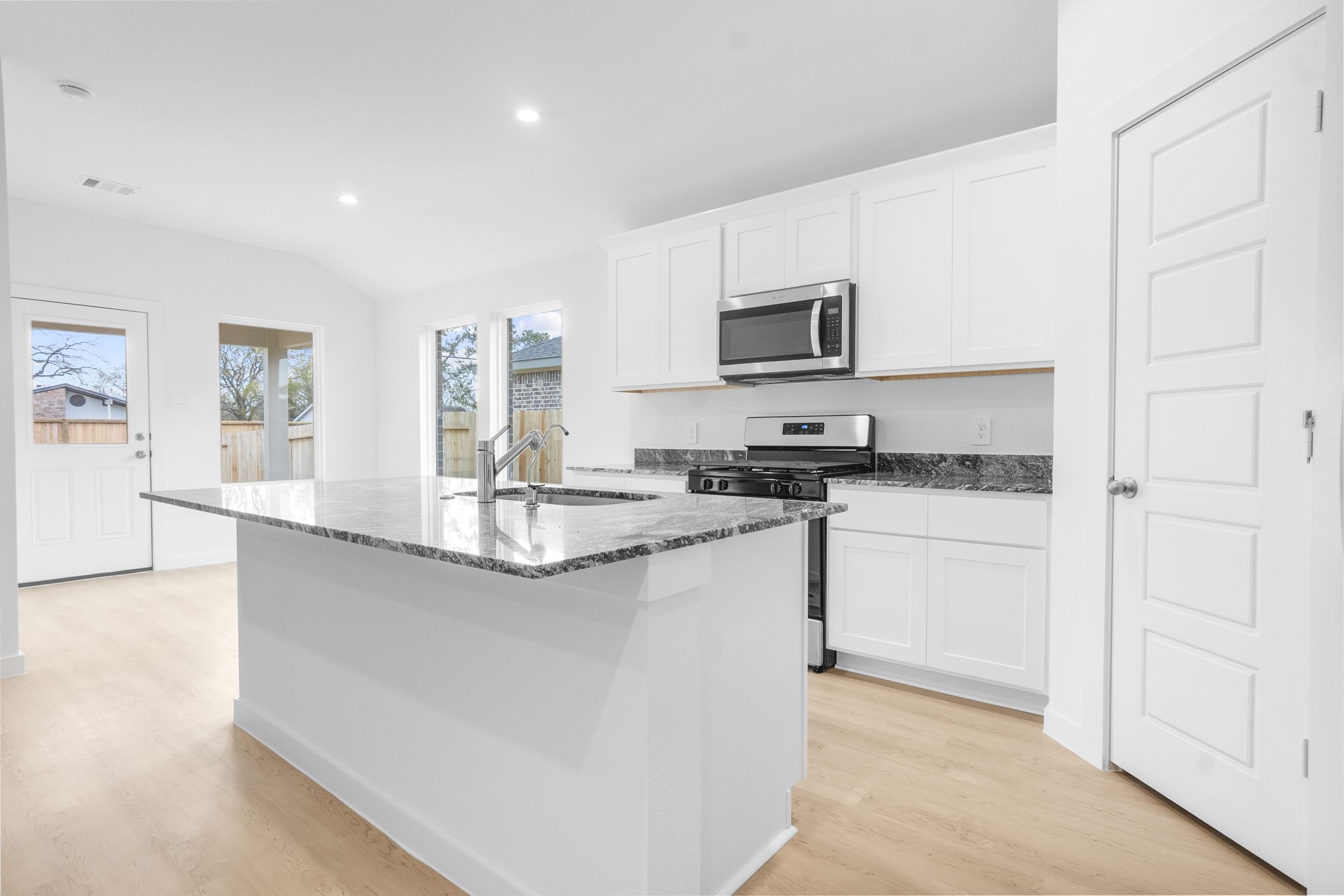 11 Robin Court Angleton, TX 77515 - Photo 2 of 21 a kitchen with stainless steel appliances granite countertop a sink and a stove top oven