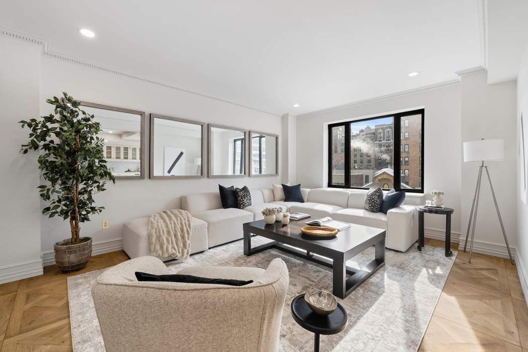 a living room with furniture and a potted plant