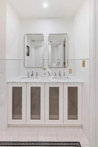 a bathroom with a sink vanity and mirror