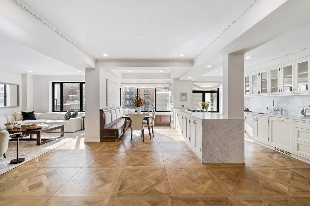 47 East 87th Street, Unit 7A Manhattan, NY 10128 - Photo 2 of 14 a living room with couches and kitchen view with wooden floor