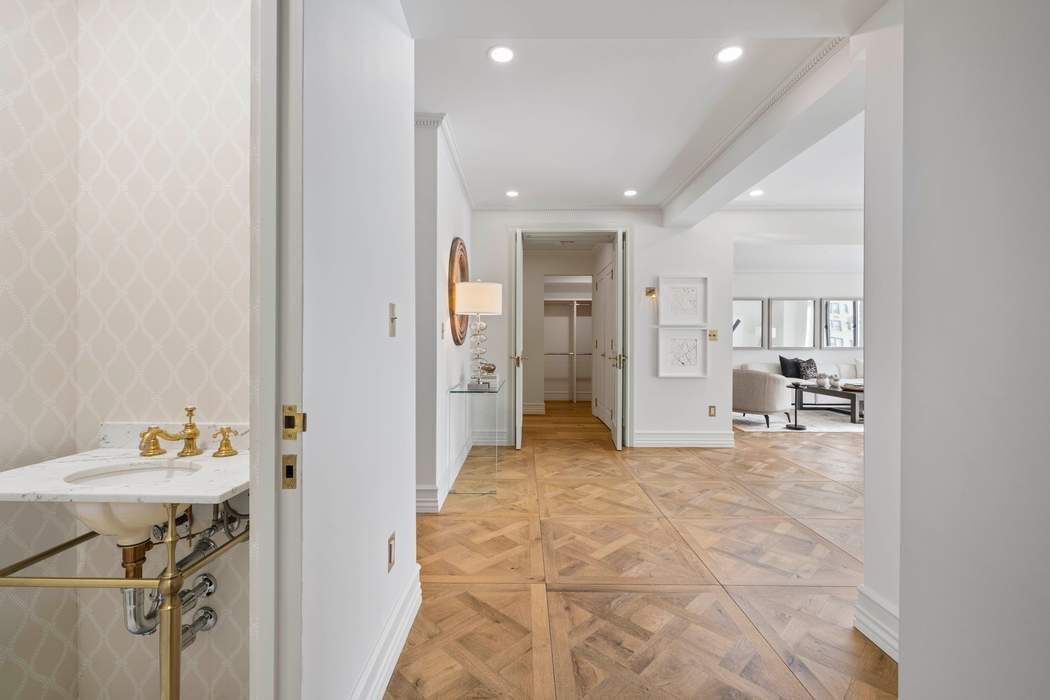 47 East 87th Street, Unit 7A Manhattan, NY 10128 - Photo 3 of 14 a view of a hallway with dining area and chandelier