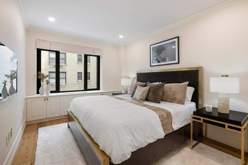 47 East 87th Street, Unit 7A Manhattan, NY 10128 - Photo 7 of 14 a bedroom with bed and a large window