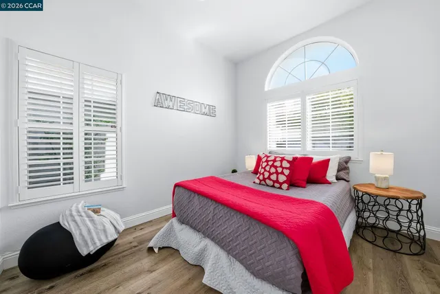 a view of a chairs and table in the back yard of a house