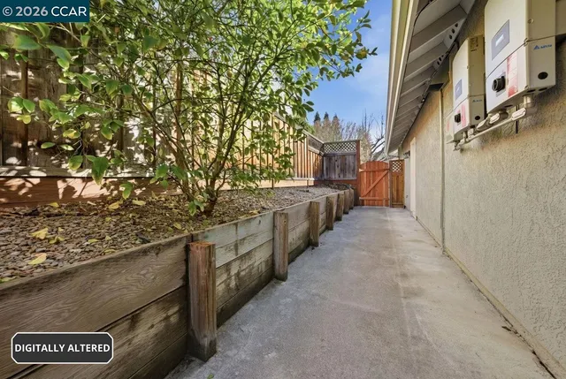 a view of a house with a yard and pathway
