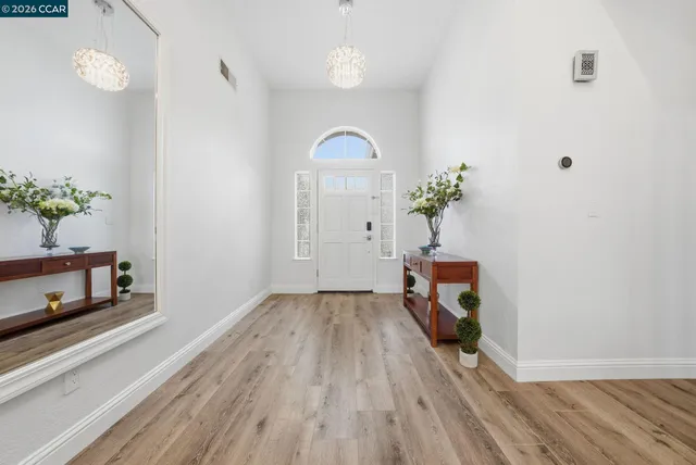 a living room with furniture and flowers