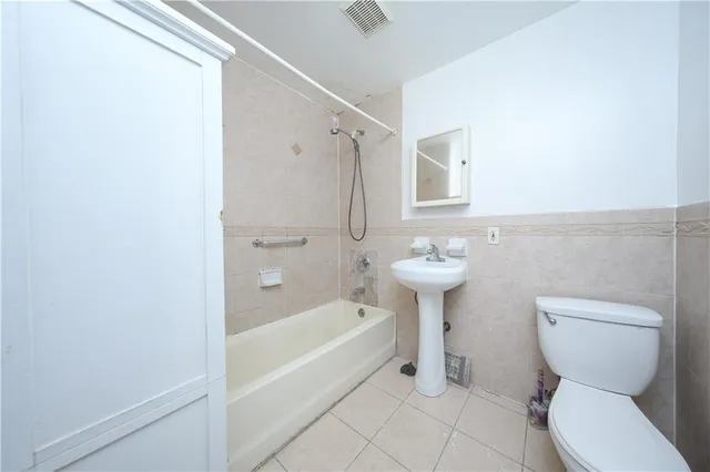 a bathroom with a sink a toilet and bathtub