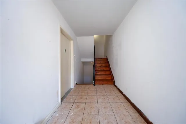 a view of a hallway with wooden floor and entryway
