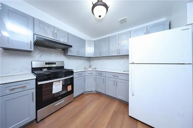 a kitchen with a stove a refrigerator and a sink